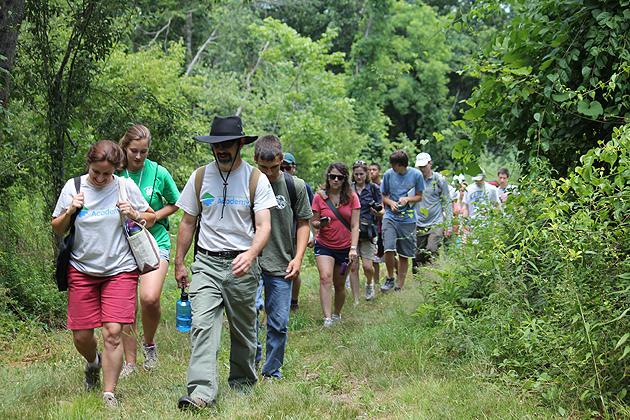 John Volin, professor of natural resources and the environment, front right, and extension educator Emily Wilson lead students into the UConn Forest.